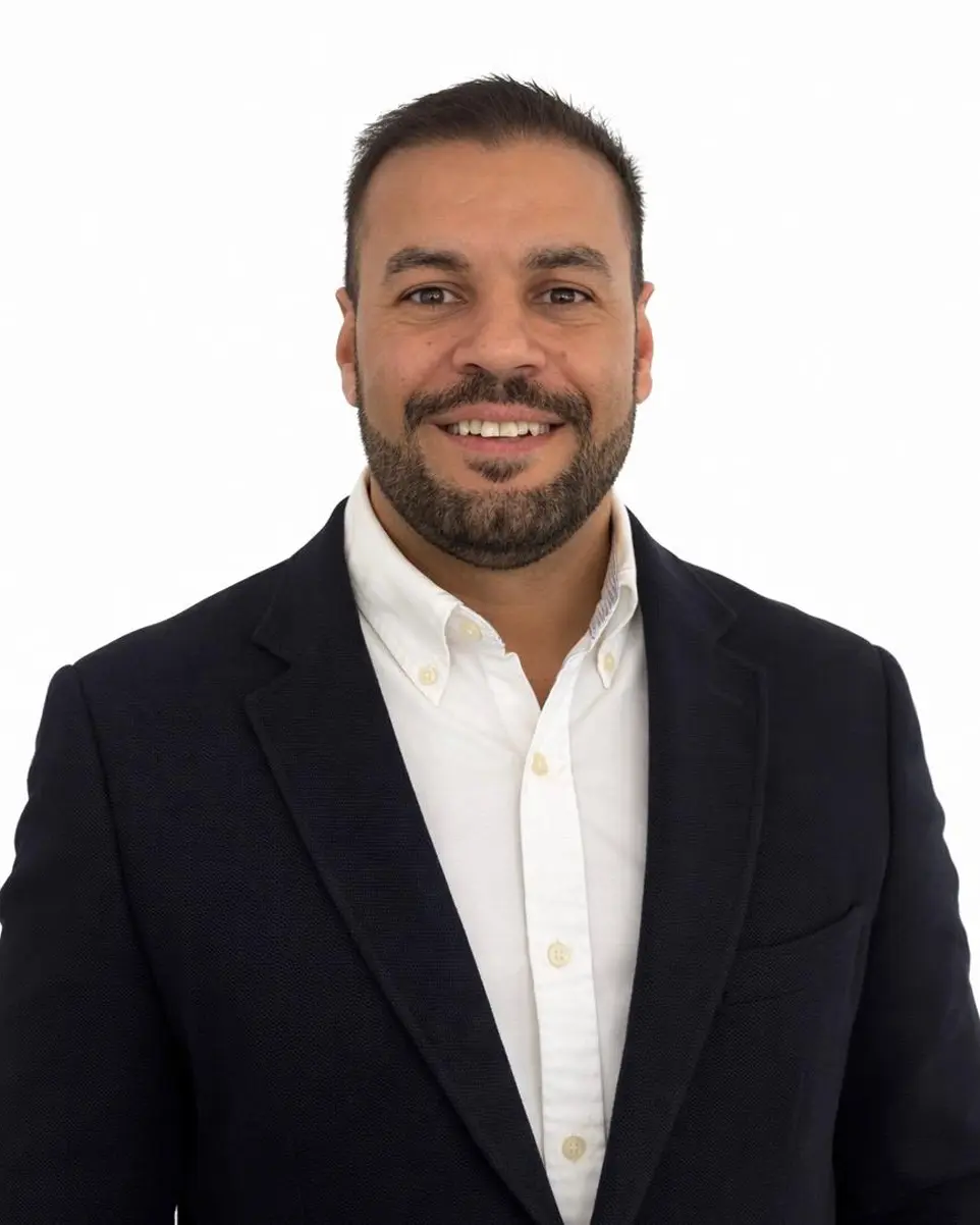 Pedro a man in a suit and tie posing for a picture